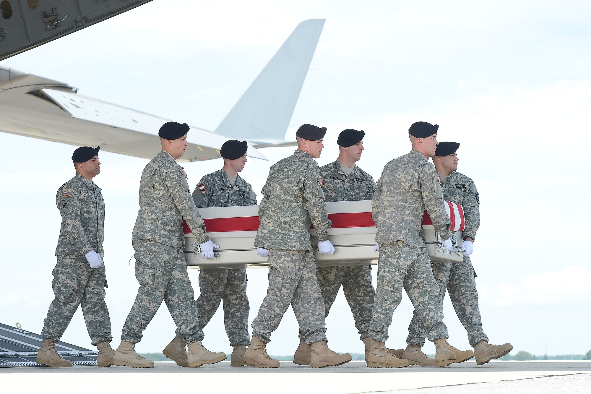 A U.S. Army carry team transfers the remains of 2nd Lt. Justin L. Sisson of Phoenix,  Ariz., during a dignified transfer June 6, 2013, at Dover Air Force Base, Del. Sisson was assigned to the 1st Battalion, 506th Infantry Regiment, 4th Brigade Combat Team, 101st Airborne Division (Air Assault) at Fort Campbell, Ky. (U.S. Air Force photo/Greg L. Davis)