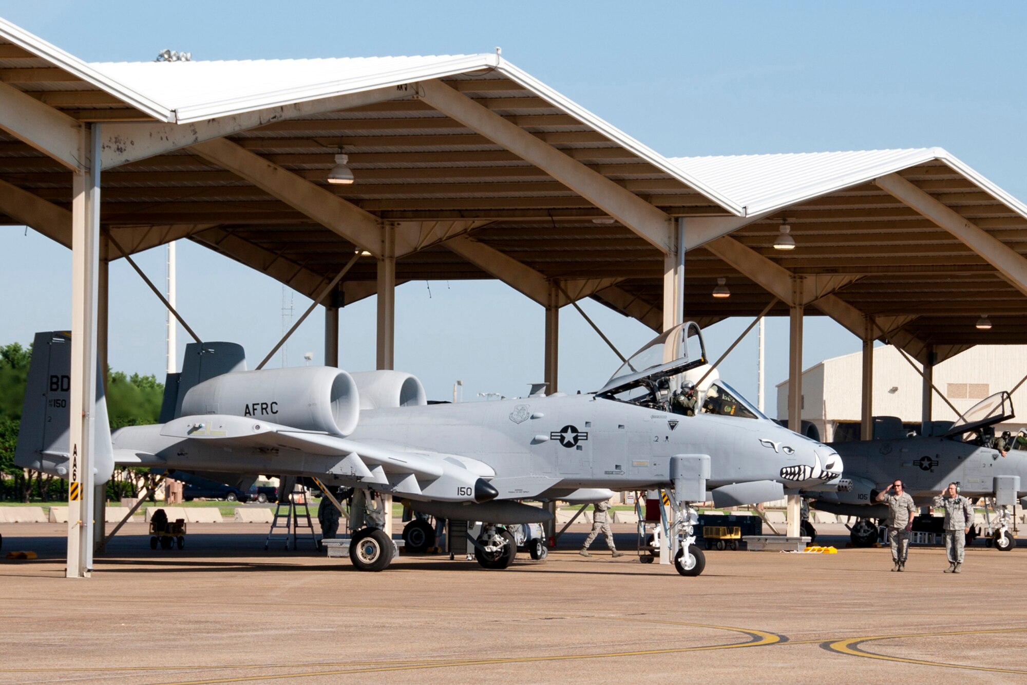 U.S. Air Force Col. John Breazeale, commander, 917th Fighter Group, salutes Chief Master Sgt. Cary Johnson, and Senior Master Sgt. Mike Thornton, as he taxis his A-10 Thunderbolt II at Barksdale Air Force Base, La., June 3, 2013. Colonel Breazeale is piloting one of six A-10s being transferred to Davis-Monthan Air Force Base, Ariz., that day. Johnson is currently the superintendent for the 917th Fighter Group, and Thornton is the production superintendent for the 917th Aircraft Maintenance Squadron. Years before, Johnson was the assistant crew chief for Thornton while he was the dedicated crew chief on that aircraft. The transfer of the A-10s from Barksdale is due to the recent Force Structure Action Implementation Plan that dictates the 917th FG at Barksdale will be inactivated this year on the last day of September. (U.S. Air Force photo by Master Sgt. Jeff Walston)