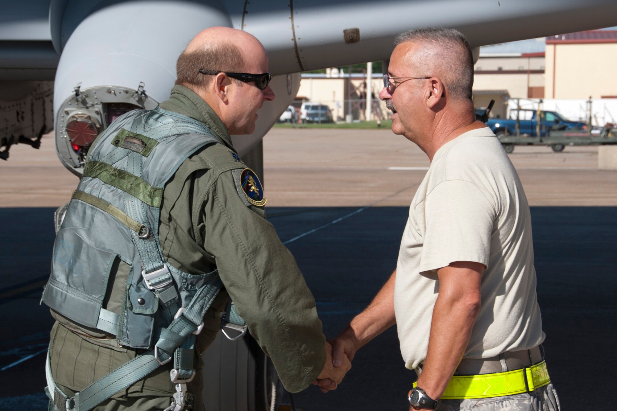 U.S. Air Force Lt. Col. James Marks, commander, 917th Operations Support Flight, shakes the hand of Tech. Sgt. Robert Berg, who is a dedicated crew chief assigned to the 717th Aircraft Maintenance Squadron, on the ramp at Barksdale Air Force Base, La., June 3, 2013. Colonel Marks is piloting one of six A-10s being transferred to Davis-Monthan Air Force Base, Ariz. The transfer of the A-10s from Barksdale is due to the recent Force Structure Action Implementation Plan that dictates the 917th Fighter Group at Barksdale will be inactivated this year on the last day of September. (U.S. Air Force photo by Master Sgt. Jeff Walston/Released)