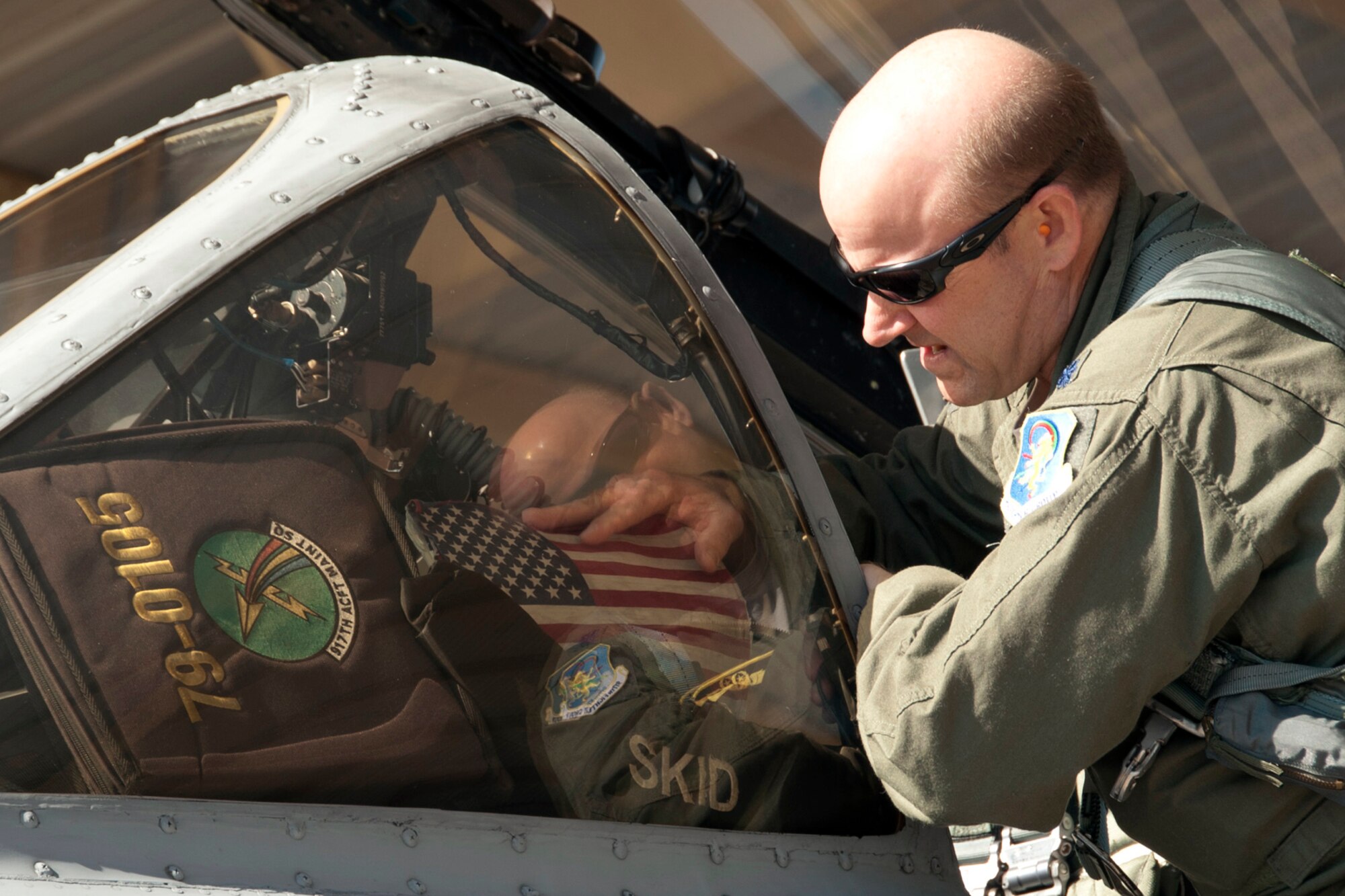 U.S. Air Force Lt. Col. James Marks, commander, 917th Operations Support Flight, places an American Flag in the cockpit of his A-10 Thunderbolt II, at Barksdale Air Force Base, La., June 3, 2013. Colonel Marks is piloting one of six A-10s being transferred to Davis-Monthan Air Force Base, Ariz. The transfer of the A-10s from Barksdale is due to the recent Force Structure Action Implementation Plan that dictates the 917th Fighter Group at Barksdale will be inactivated this year on the last day of September. (U.S. Air Force photo by Master Sgt. Jeff Walston)
