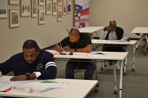 Master Sgt. Demetrius Booth, played the role of McGeorge Bundy, National Security Advisor, Master Sgt. Eric Kennedy, played the role of General Earle Wheeler, Chairman Joint Chief of Staff and Tech. Sgt. Alexander Rodriguez a team member, study the contemporary evidence before the role-playing the descision to enter Vietnam at the Lyndon B. Johnson Presidential Museum in Austin, Texas. The NCOs are members of the cadre from the 343rd Training Squadron. The group learned what pressures this nation's leaders faces before the decision to enter the Vietnam conflict.(U.S. Air Force Courtesy Photo)