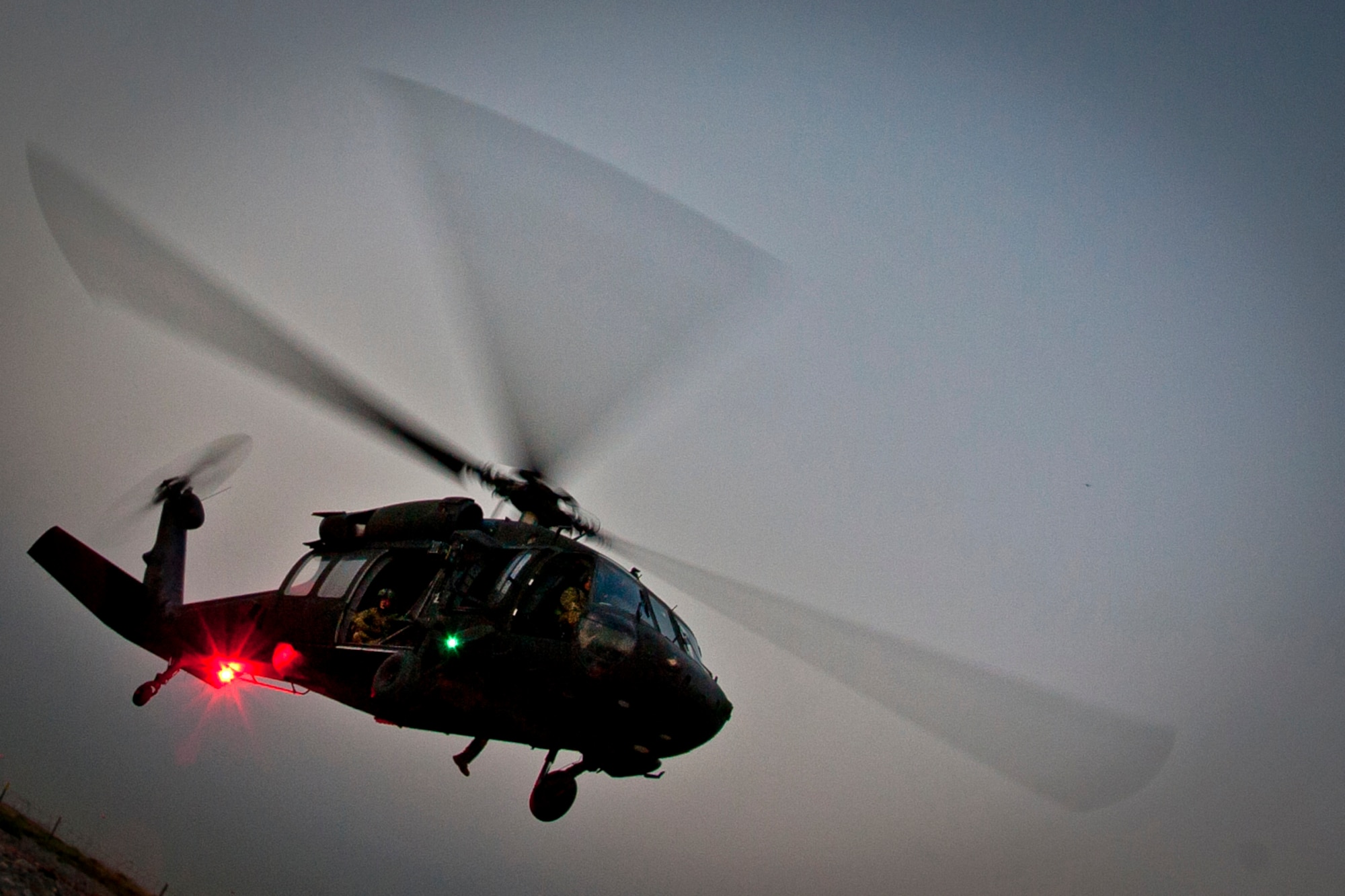 A UH-60 Black Hawk helicopter approaches the landing zone during a joint-coalition sling load training mission at Kandahar Airfield, Afghanistan, June 1, 2013. The training provided coalition members the opportunity to learn the concepts of marking and illuminating a landing zone as well as in-flight cargo sling loading. (U.S. Air Force photo/Senior Airman Scott Saldukas)
