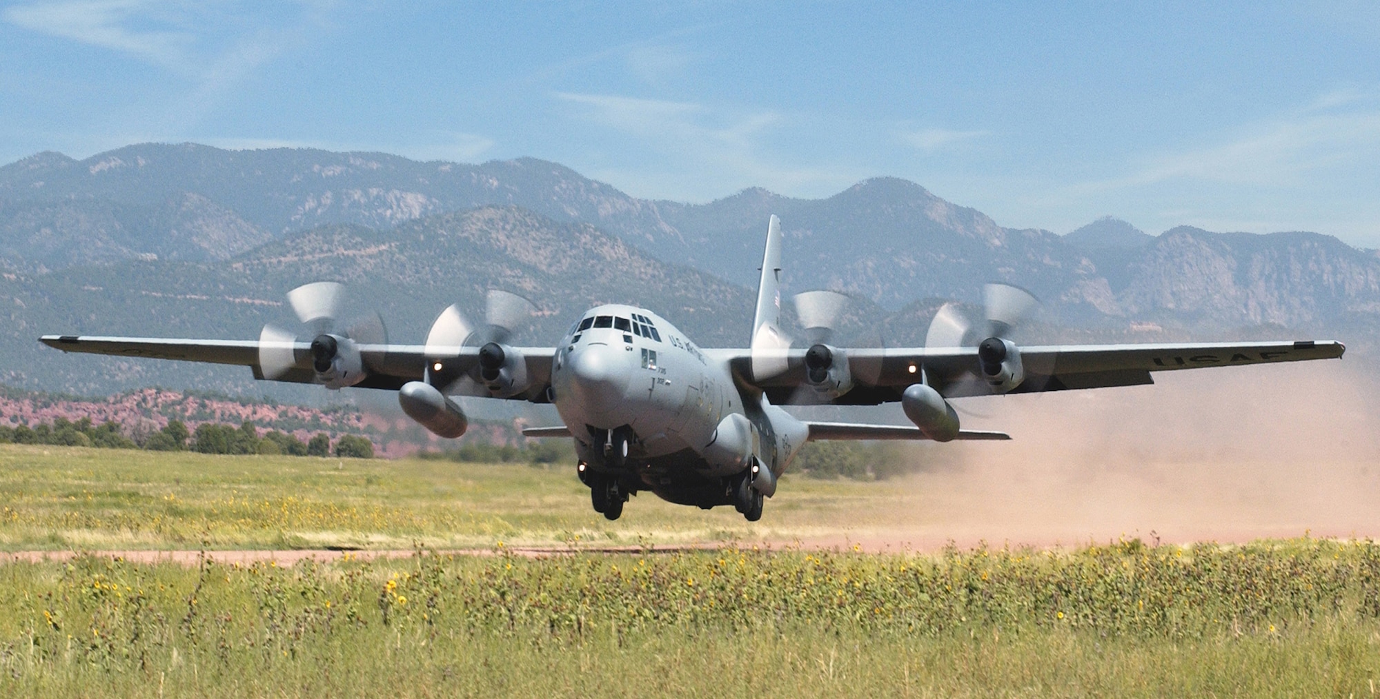 A C-130 aircraft from the Air Force Reserve Command’s 302nd Airlift Wing uses unimproved runways during training at Red Devil tactical airstrip at Ft. Carson, Colo. Landings cause rocks and other debris to hit the underside of the aircraft. The 302nd Maintenance Group started adding protective tape to the struts to alleviate the damage. (U.S. Air Force photo/Chief Master Sgt. James Riley)