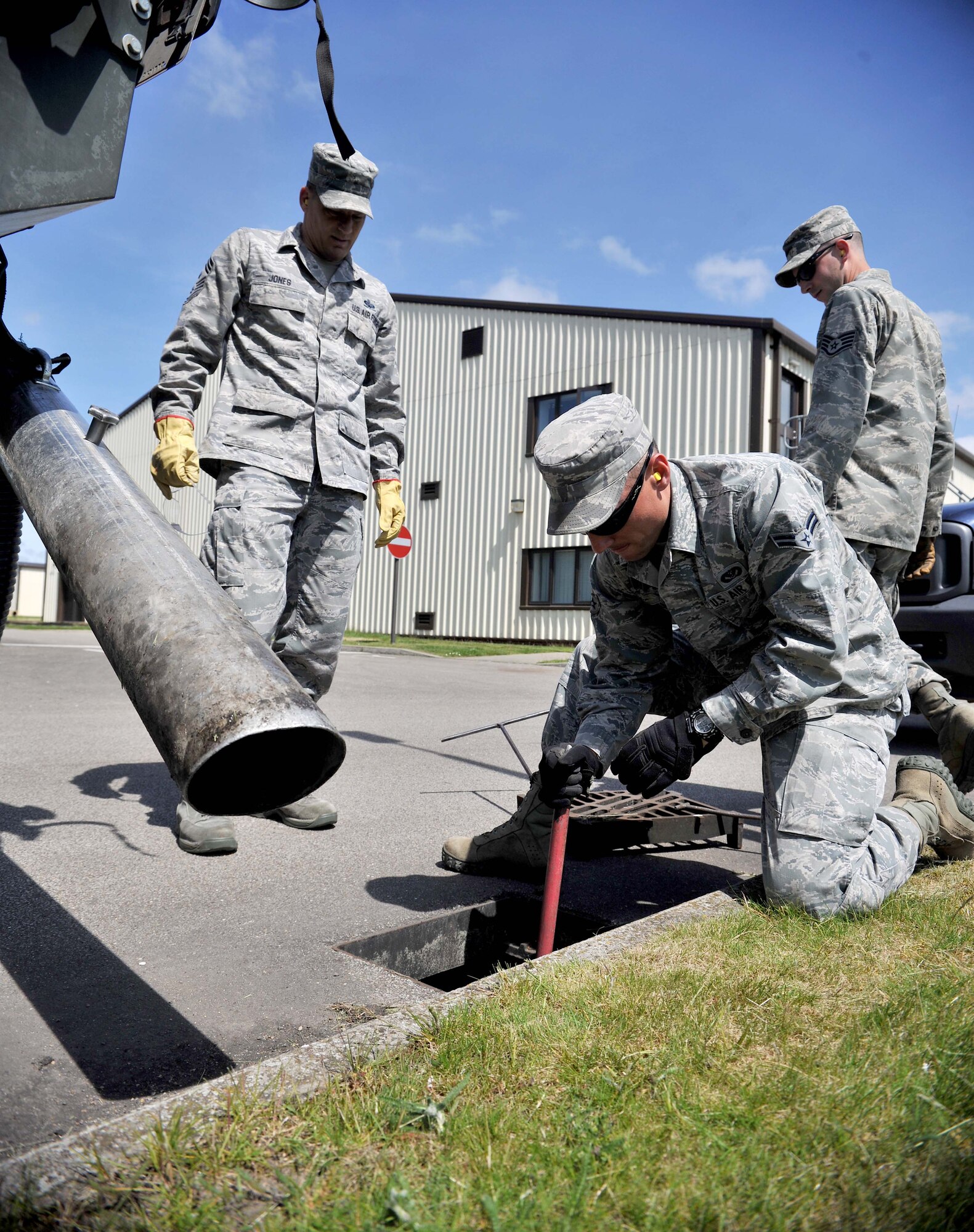 Airman 1st Class Steven Beasley, 100th Civil Engineer Squadron Horizontal Shop pavements and construction journeyman from Roseville, N.C., breaks up debris collected in the base’s sub-surface drainage system June 5, 2013, on RAF Mildenhall, England. The 100th CES Horizontal Shop is responsible for clearing debris from each drain on base to help mitigate base-wide flooding and to maintain structural integrity of the base’s infrastructure. (U.S. Air Force photo by Staff Sgt. Jerilyn Quintanilla/Released)