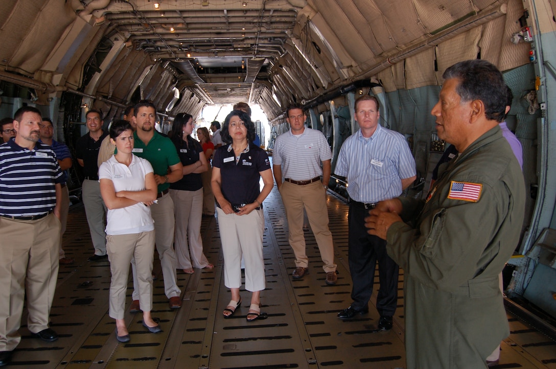 Senior Master Sgt. Charles Cardenas, a 356th Airlift Squadron loadmaster, explains his duties inside a C-5A Galaxy's cargo hold to participants of Leadership San Antonio Class 38 during their visit June 5, 2013 to the 433rd Airlift Wing. The tour was part of the day's events which highlighted the diverse missions of Joint Base San Antonio-Lackland and focused on military and veterans' affairs.