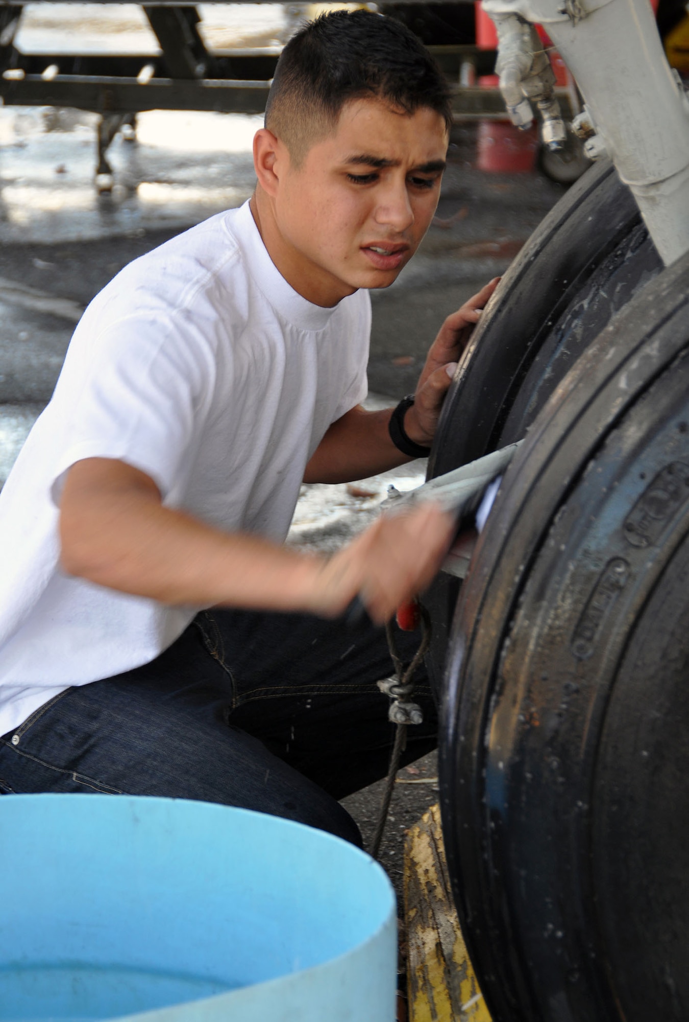 TRAVIS AIR FORCE BASE, Calif. -- Senior Airman Joe Guizar, C-5 loadmaster, with the 312th Airlift Squadron, washes a C-119 recently adopted by his unit at the Travis Heritage Center on June 2, 2013. The 312th AS will maintain the plane clean, make repairs and restore it. (U.S. Air Force photo / Senior Airman Cindy G. Alejandrez)