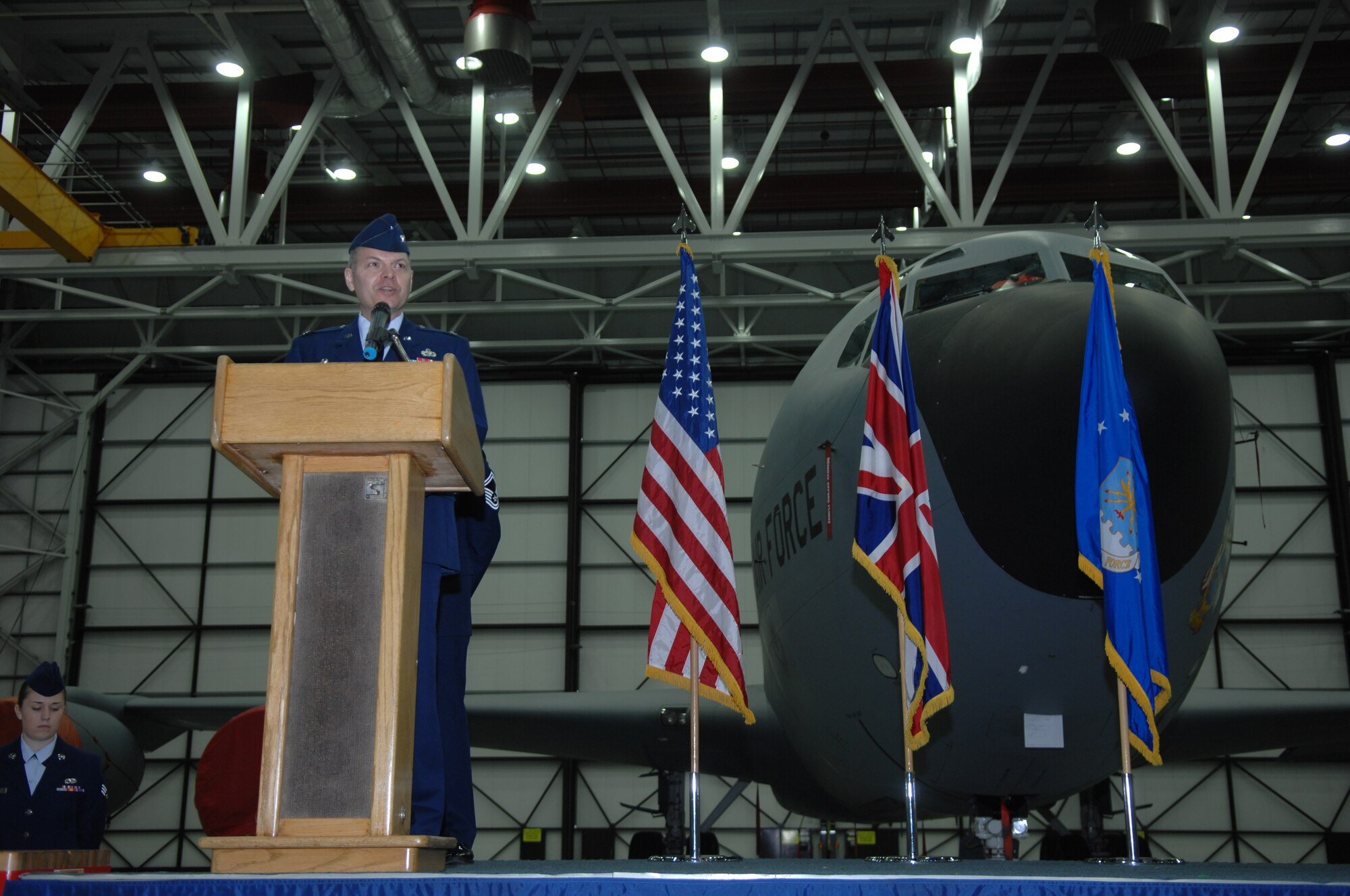 Col. Joseph Rushlau, 100th Maintenance Group commander, addresses the audience June 6, 2013, during the 100th Maintenance Squadron Change of Command ceremony in Hangar 814 on RAF Mildenhall, England. Rushlau presided over the ceremony and acted as the official transferring command. (U.S. Air Force photo by Airman 1st Class Dillon Johnston/Released)
