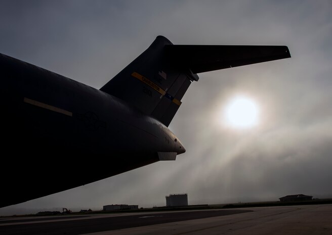Fog rolls across the Joint Base Charleston flightline as the sun rises above A C-17 Globemaster III June 4, 2013 at JB Charleston – Air Base, S.C. The first C-17 to enter the Air Force’s inventory arrived at Charleston Air Force Base in June 1993. The C-17 is capable of rapid strategic delivery of troops and all types of cargo to main operating bases or directly to forward bases in the deployment area. (U.S. Air Force photo/Senior Airman Dennis Sloan)