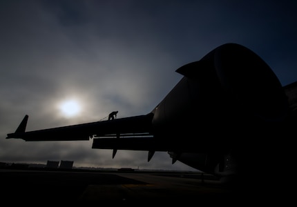 Tech. Sgt. Andrew Gravett, 437th Aircraft Maintenance Squadron crew chief, walks along the top of a C-17 Globemaster III wing while wearing a safety harness as he does a routine maintenance check of the aircraft June 4, 2013, at Joint Base Charleston – Air Base, S.C. The first C-17 to enter the Air Force’s inventory arrived at Charleston Air Force Base in June 1993. The C-17 is capable of rapid strategic delivery of troops and all types of cargo to main operating bases or directly to forward bases in the deployment area. (U.S. Air Force photo/Senior Airman Dennis Sloan)