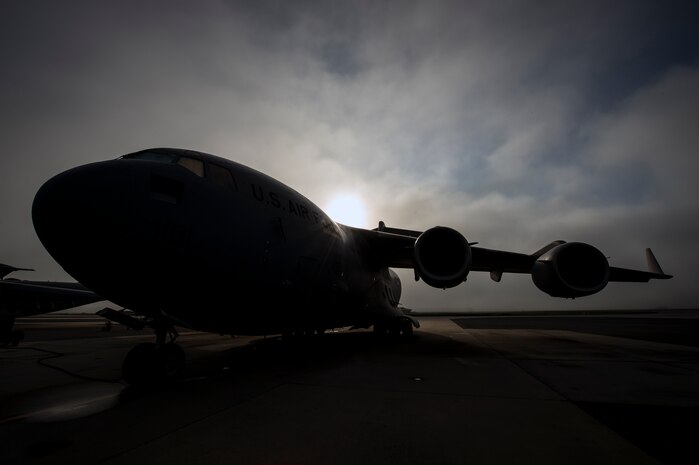Fog rolls across the Joint Base Charleston flightline as the sun rises above A C-17 Globemaster III June 4, 2013, at JB Charleston, S.C. The first C-17 to enter the Air Force’s inventory arrived at Charleston Air Force Base in June 1993. The C-17 is capable of rapid strategic delivery of troops and all types of cargo to main operating bases or directly to forward bases in the deployment area. (U.S. Air Force photo/Senior Airman Dennis Sloan)