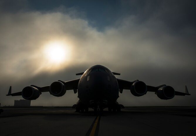 Fog rolls across the Joint Base Charleston flightline as the sun rises above A C-17 Globemaster III June 4, 2013, at JB Charleston – Air Base, S.C. The first C-17 to enter the Air Force’s inventory arrived at Charleston Air Force Base in June 1993. The C-17 is capable of rapid strategic delivery of troops and all types of cargo to main operating bases or directly to forward bases in the deployment area. (U.S. Air Force photo/Senior Airman Dennis Sloan)