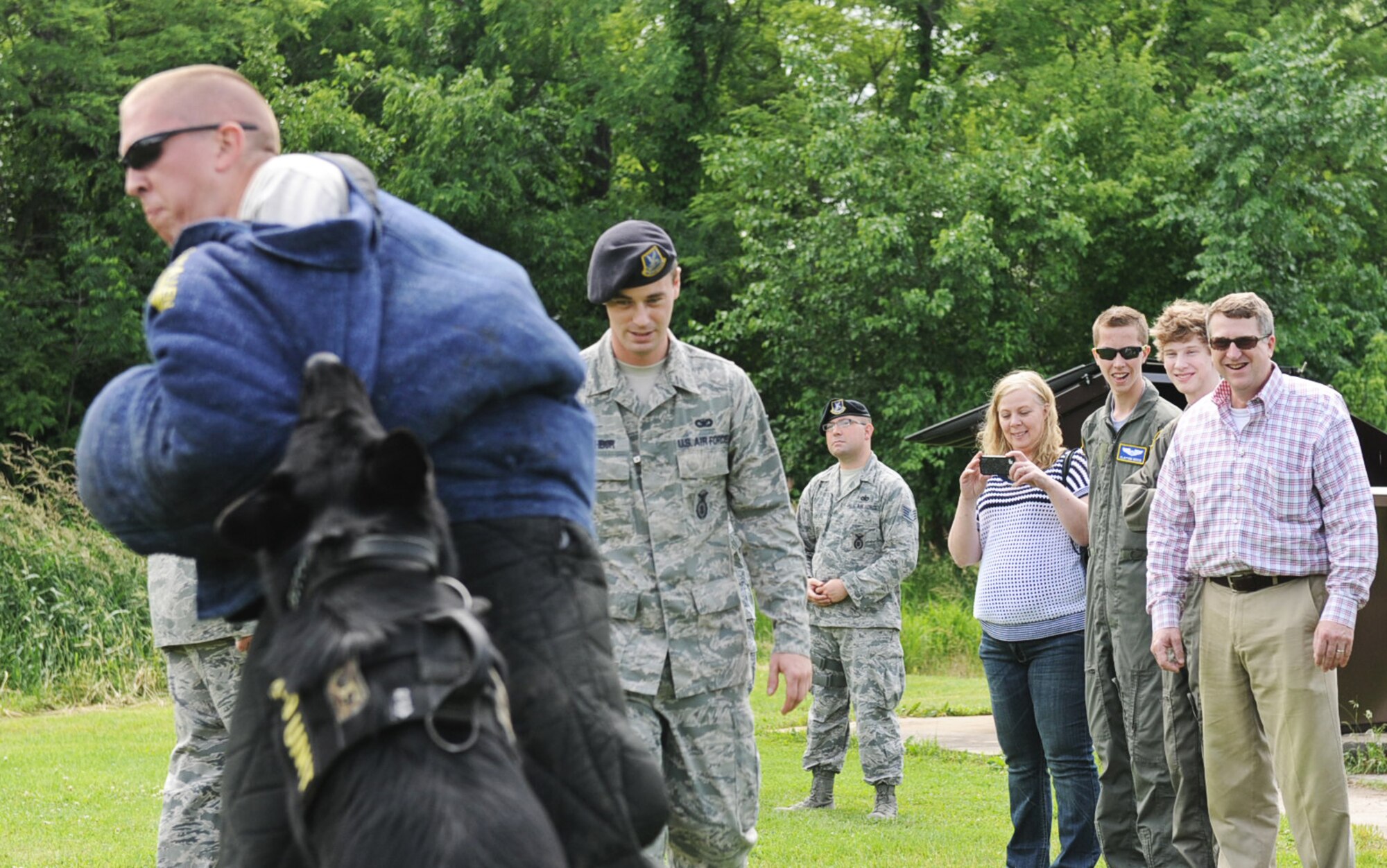 The Reese family watches as members of the 375th Security Forces Squadron
demonstrate the capabilities of the military working dogs, May 31. Clayton, 18, and his brother, Zachary Reese, 15, were born with Cystic Fibrosis, which resulted in frequent lung infections that are treated with antibiotics and other medications, became pilots for a day through the Pilot for a Day program. This program brings chronically ill children to the base for a tour, as well as a chance to ride in one of the Wings of Hope aircraft. (U.S. Air Force photo/Senior Airman Jake Eckhardt)