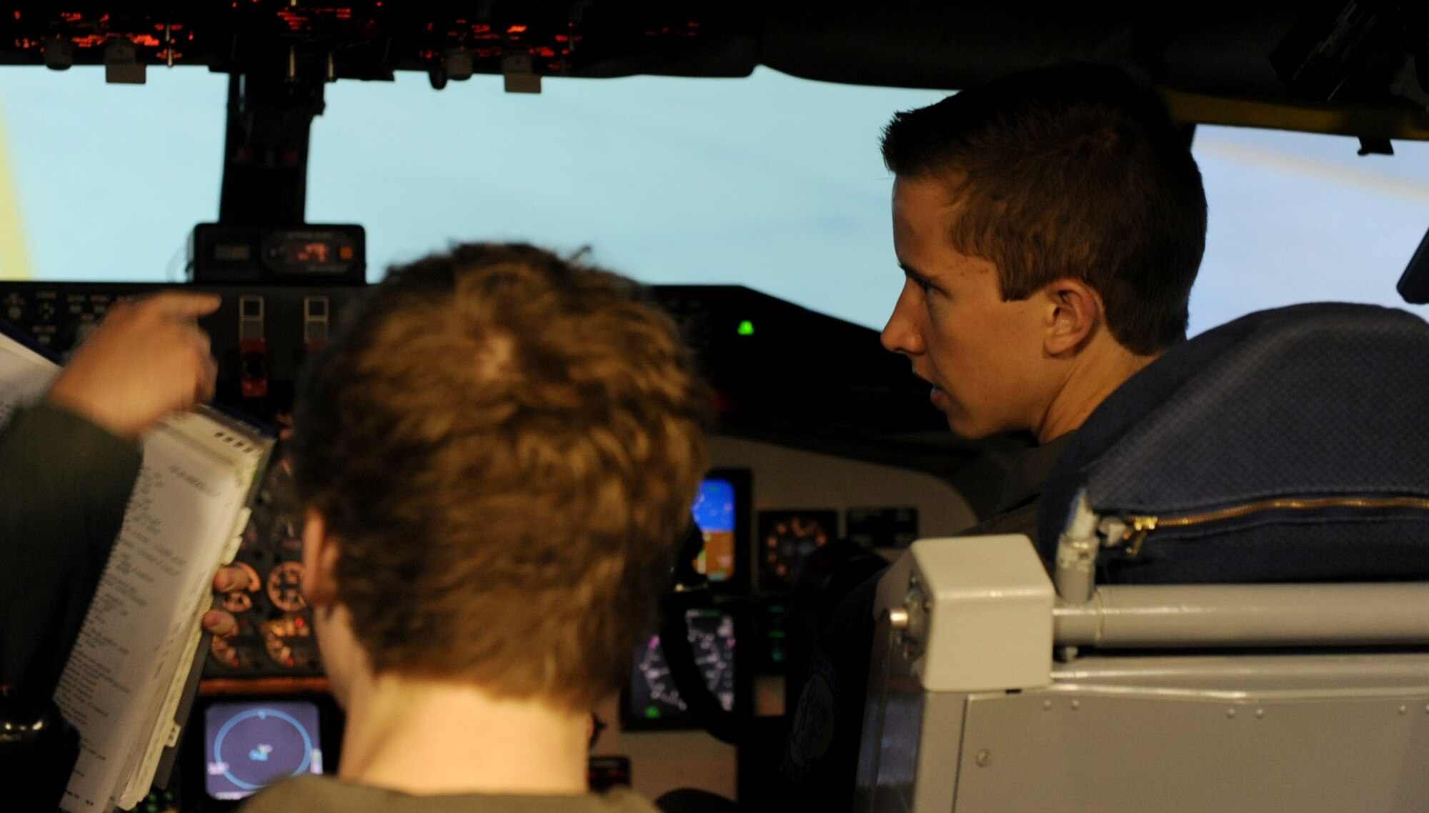 Clayton Reese, Pilot for a Day, gets taught how to land in the KC-135 simulator, May 31. Clayton, 18, and his brother, Zachary Reese, 15, were born with Cystic Fibrosis, which resulted in frequent lung infections that are treated with antibiotics and other medications, became pilots for a day through the Pilot for a Day program. This program brings chronically ill children to the base for a tour, as well as a chance to ride in one of the Wings of Hope aircraft. (U.S. Air Force photo/Senior Airman Jake Eckhardt)