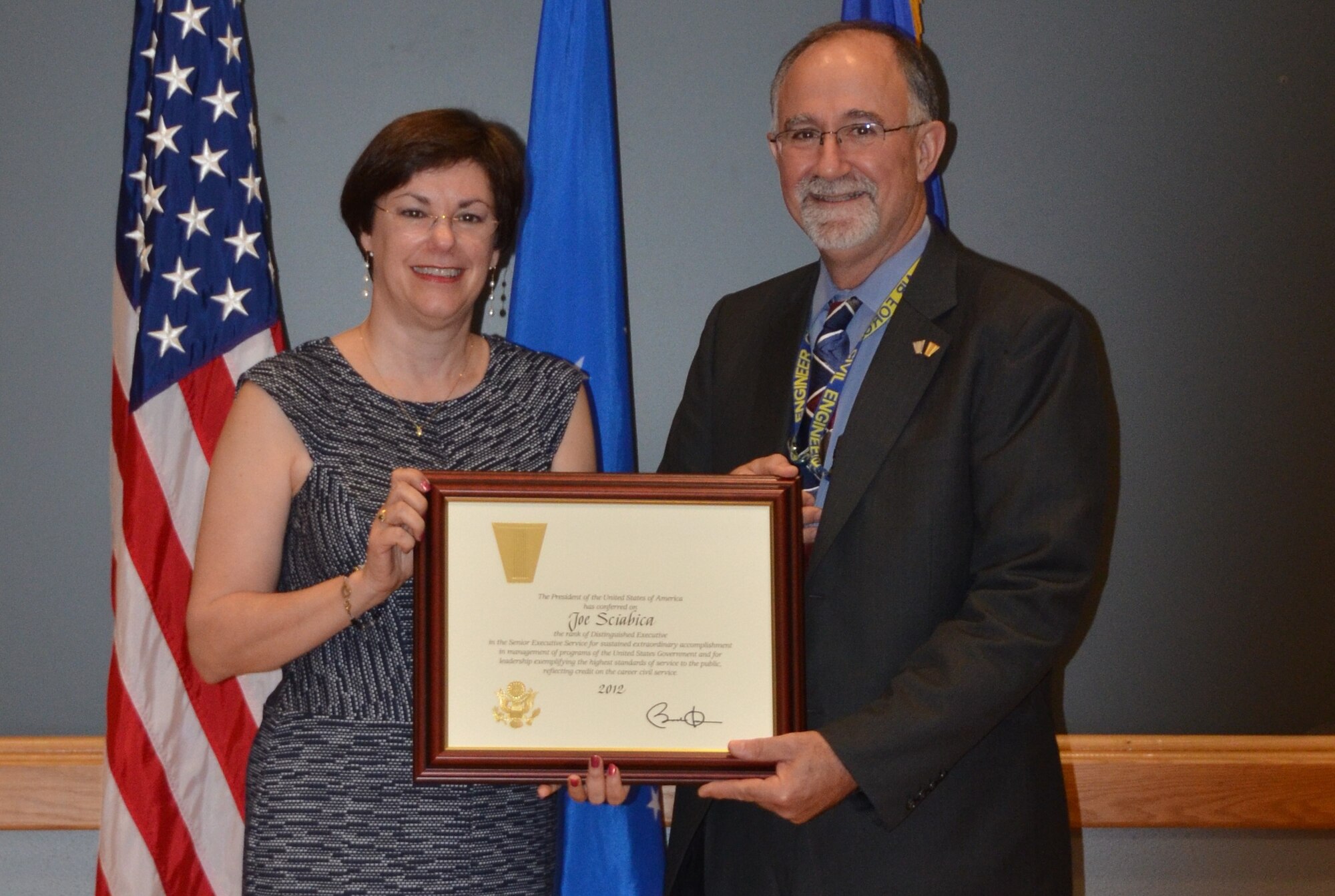 Patricia Young presents Air Force Civil Engineer Center Director Joe Sciabica with the 2012 Presidential Distinguished Rank Award during a ceremony at Joint Base San Antonio-Lackland, Texas, June 5. The award is the ultimate achievement in the career of a senior leader and only one percent of all senior executive service members will earn it. Sciabica was awarded for his work as the executive director of the Air Force Research Laboratory at Wright-Patterson Air Force Base, Ohio. Young is the Air Force assistant deputy chief of staff for logistics, installations, and mission support. (U.S. Air Force photo/Jason Goode)