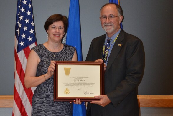 Patricia Young presents Air Force Civil Engineer Center Director Joe Sciabica with the 2012 Presidential Distinguished Rank Award during a ceremony at Joint Base San Antonio-Lackland, Texas, June 5. The award is the ultimate achievement in the career of a senior leader and only one percent of all senior executive service members will earn it. Sciabica was awarded for his work as the executive director of the Air Force Research Laboratory at Wright-Patterson Air Force Base, Ohio. Young is the Air Force assistant deputy chief of staff for logistics, installations, and mission support. (U.S. Air Force photo/Jason Goode)