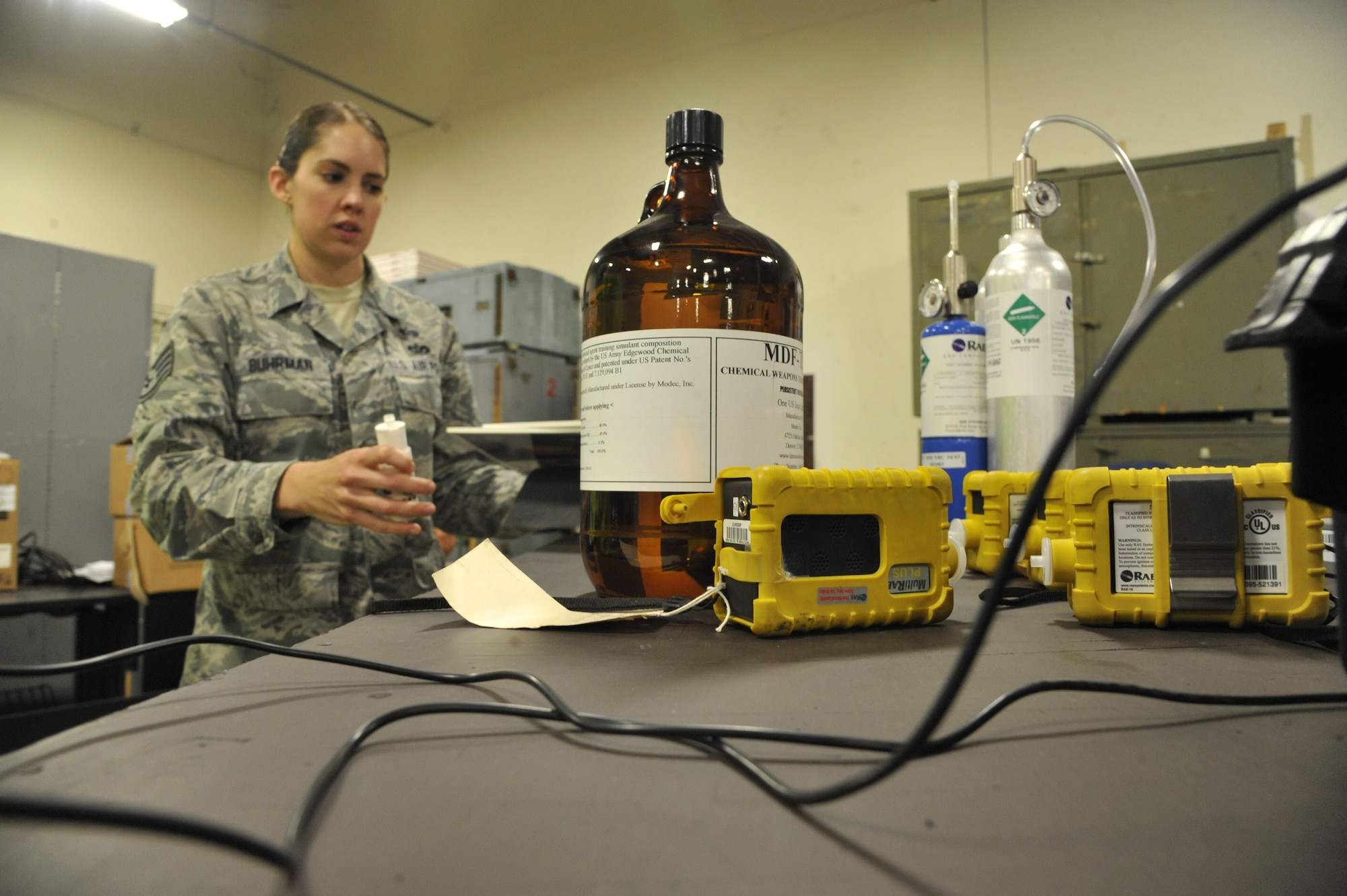 Staff Sgt. Rebecca Buhrman, 509th Civil Engineer Squadron NCO in charge of emergency management logistics, gathers powders and liquids at Whiteman Air Force Base, Mo., May 22, 2013. These liquids and powders are used for training purposes to ensure emergency management team readiness. (U.S. Air Force photo by Airman 1st Class Keenan Berry/Released)
