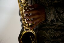 MINOT AIR FORCE BASE, N.D. – Senior Airman Keith DeBose, 5th Medical Operations Squadron medical standards technician, plays the National Anthem on his saxophone during the 5th Maintenance Operations Squadron inactivation ceremony, May 31. The inactivation of the squadron is part of a Headquarters Air Force effort to make available additional officer positions from the ranks of junior and mid-grade level Majors. The Air Force Chief of Staff approved the inactivation of all MOS Air Force-wide, except in Intercontinental Ballistic Missile Wings. (U.S. Air Force photos/Senior Airman Brittany Y. Auld)