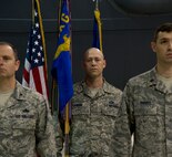 MINOT AIR FORCE BASE, N.D. -- Col. Eric Froehlich, 5th Maintenance Group commander (left), Master Sgt. Christopher Lawson (center), 5th Maintenance Operations Squadron acting first sergeant, and Maj. Aaron River (right), 5th MOS outgoing commander, stand at attention while the orders are published during the 5th MOS inactivation ceremony, May 31. The inactivation of the squadron is part of a Headquarters Air Force effort to make available additional officer positions from the ranks of junior and mid-grade level Majors. The Air Force Chief of Staff approved the inactivation of all MOS Air Force-wide, except in Intercontinental Ballistic Missile Wings. (U.S. Air Force photos/Senior Airman Brittany Y. Auld)