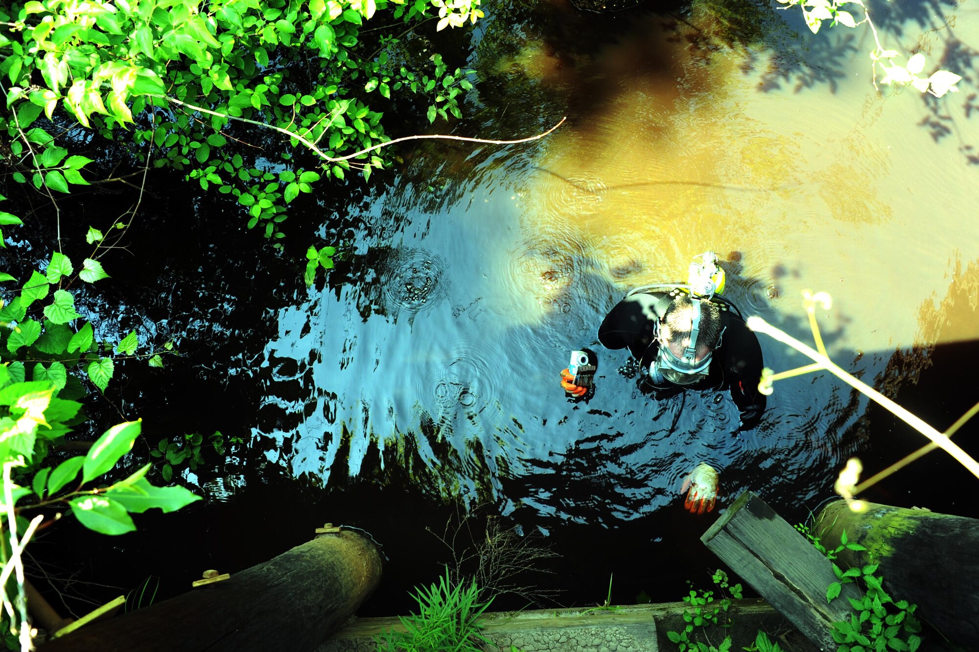 Stephen England, U.S. Army Corps of Engineers hydraulic engineer, uses sonar equipment to gauge the depth of a bridge’s foundation below water May, 30, 2013, at Joint Base McGuire-Dix-Lakehurst, N.J. Gauging the depth of the foundation can be cross analyzed with previous recordings to determine if the foundation has shifted over time. (U.S. Air Force photo by Airman Sean M. Crowe/Released)