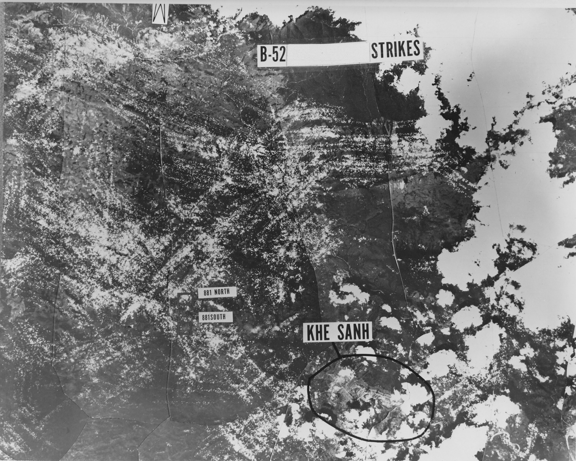 The intensive B-52 bombardment of enemy forces at Khe Sanh was shown by this montage pieced together from reconnaissance photos. White dots indicate where bombs fell (white areas on right show cloud cover). The heavy saturation of pock marks in the enemy-held area above Khe Sanh shows the remarkable accuracy of the B-52s. (U.S. Air Force photo)