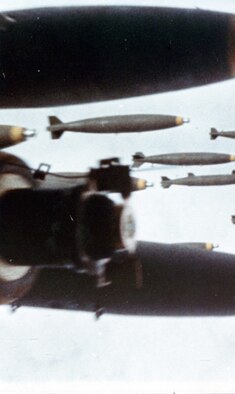 As seen from another aircraft, bombs released from a B-52 fall on communist forces attacking Khe Sanh. The aerial bombing campaign in support of the besieged American forces at Khe Sanh was named OPERATION NIAGARA for this “waterfall” of bombs. (U.S. Air Force photo)