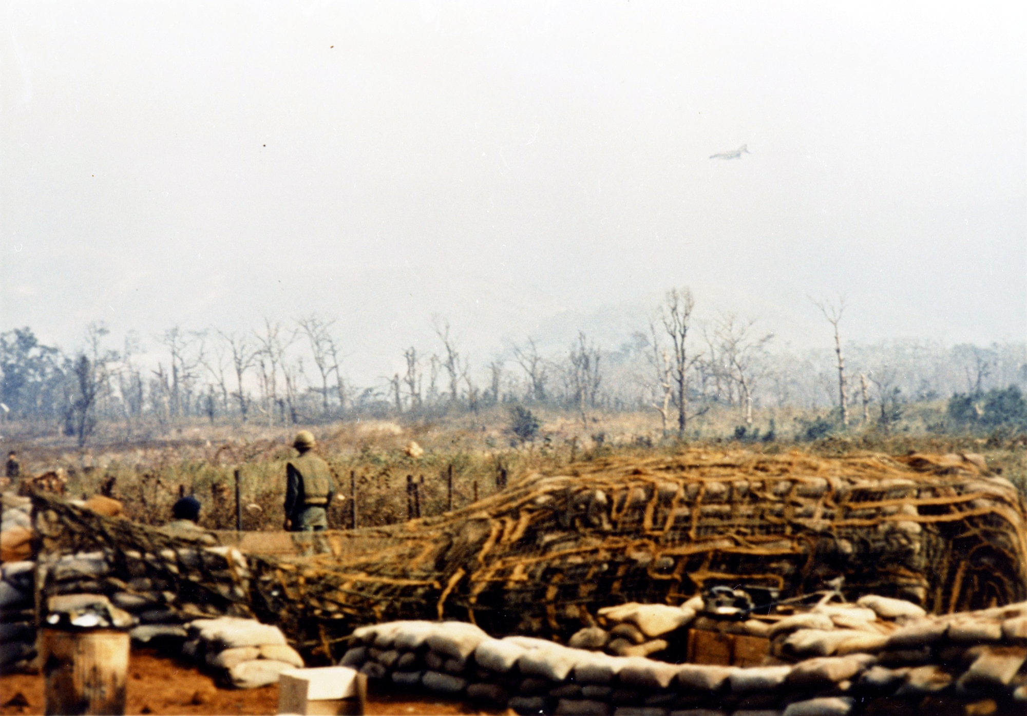 Besieged U.S. Marines at Khe Sanh, Vietnam, watch as a U.S. Air Force F-4 makes close air support strike over the area. (U.S. Air Force photo)
