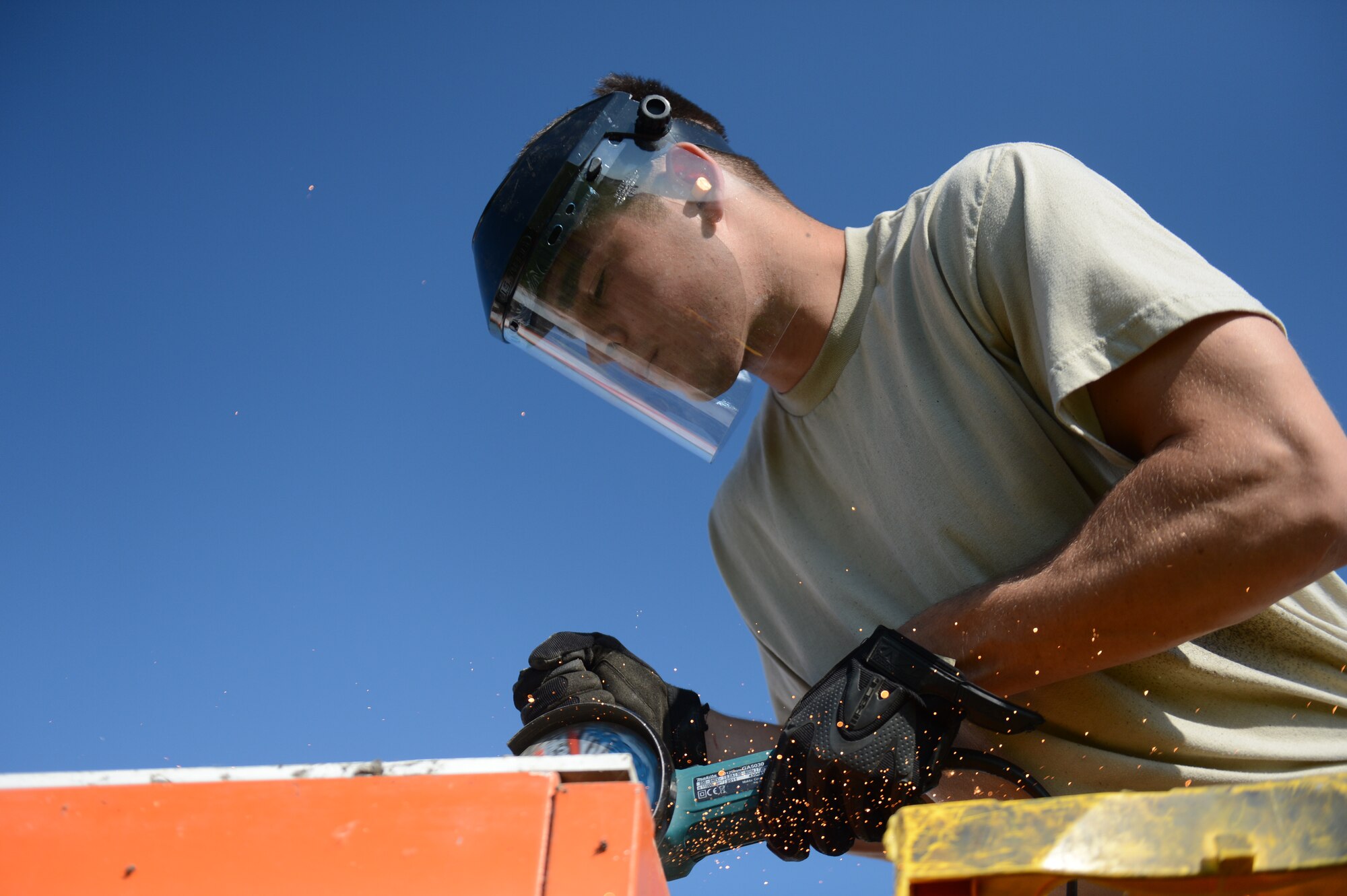SPANGDAHLEM AIR BASE, Germany – U.S. Air Force Airman 1st Class John Holt, 52nd Civil Engineer Squadron structural technician from Paso Robles, Calif., saws the top of a metal shack on the flightline June 6, 2013. The 52nd CES is working with contractors to improve the existing runway by removing unneeded structures and reinforcing the pavement. (U.S. Air Force photo by Airman 1st Class Gustavo Castillo/Released)