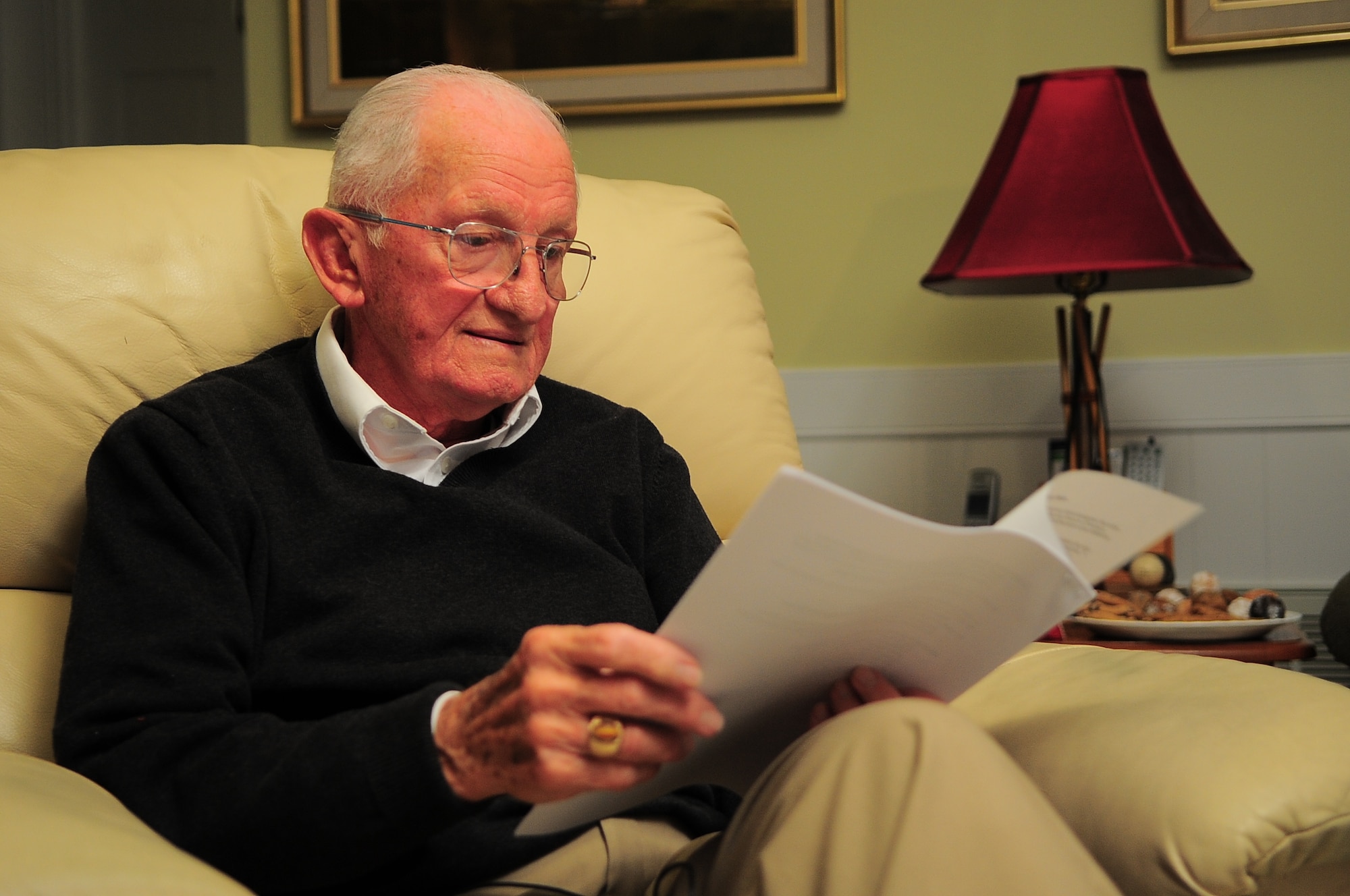 U.S. Air Force retired Lt. Col. Harry Pawlik reviews a speech written in his honor at his home in Greenville, N.C., Jan. 3, 2013. Pawlik, a World War II concentration camp survivor, recalled several obstacles from the time he was captured by Nazi forces at the age of 10, to the day he graduated from the Naval War College during a recent interview. (U.S. Air Force photo/Airman 1st Class Aubrey White/Released)
