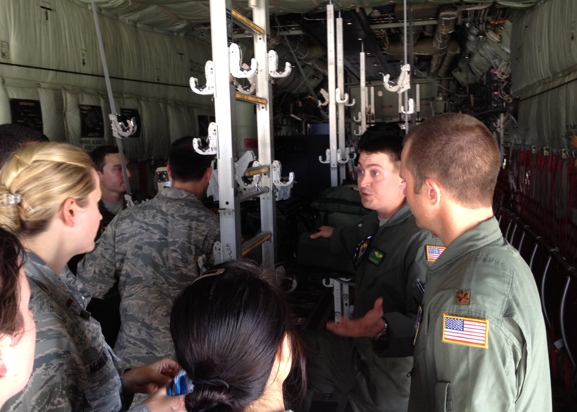 Maj. (Dr.) George Kotti, second from right, instructs several USUHS students with Maj. (Dr.) Shawn French aboard a 53rd Weather Reconnaissance Squadron C-130J Hercules set up to carry patients May 9. The students are, from left:  Public Health Service Ensign Soo Ha, 2nd Lt. Kelly McMullan, 2nd Lt. John Laskoski and Army 2nd Lt. Ally Ha (back to camera). Kotti and French are both pulmonary/critical care physicians assigned to the 81st Medical Operations Squadron.  (Photo by Capt. (Dr.) Noah Gudel)
