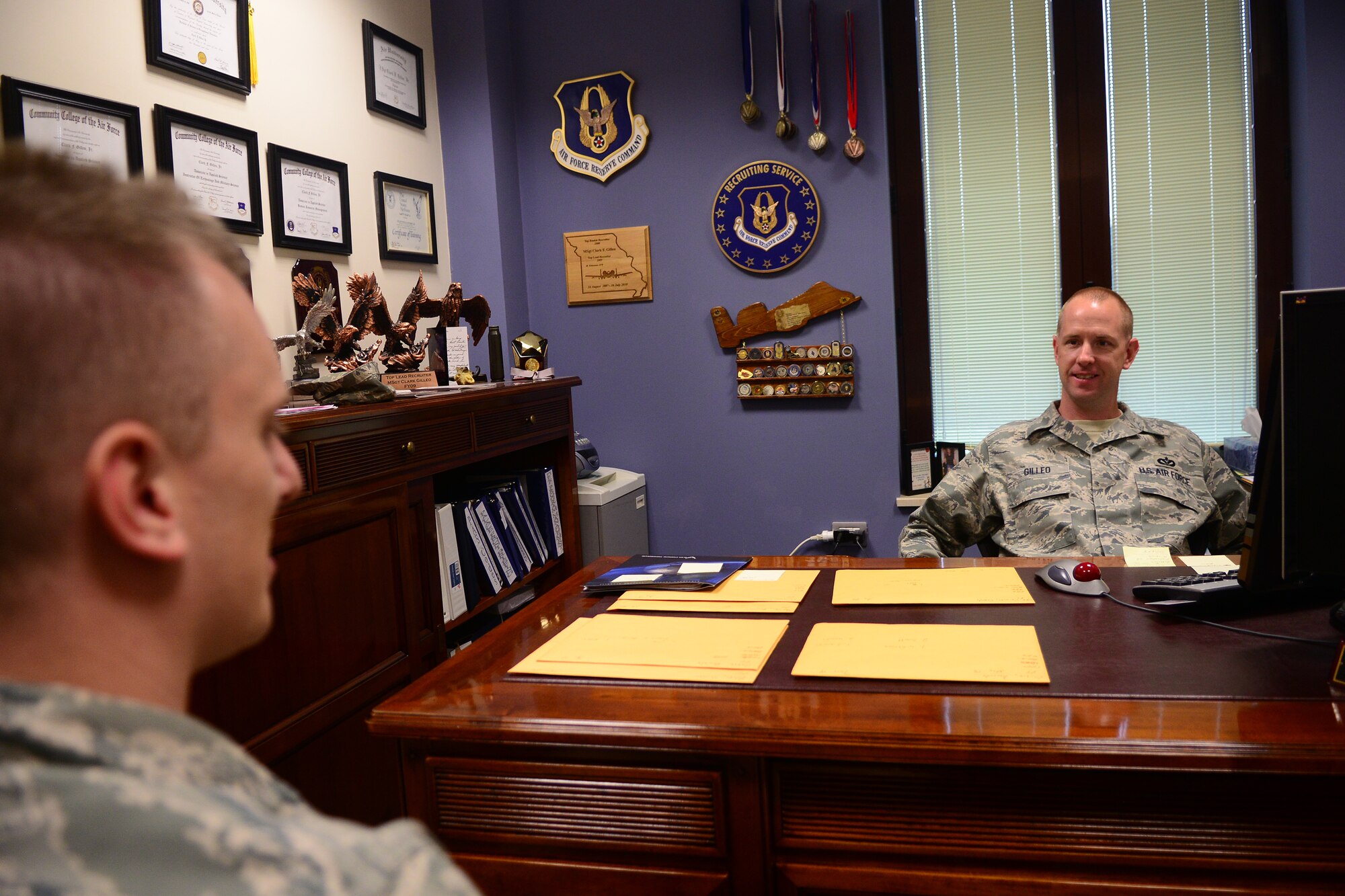 (Left) Tech. Sgt. Robert Baarstad, 31st Munitions Squadron munitions storage production supervisor, speaks with Master Sgt. Clark Gilleo, 31st Force Support Squadron in-service recruiter, about the benefits the Air Force Reserve offers May 16, 2013, at Aviano Air Base, Italy. During his tour at Aviano, Gilleo helped more than 120 Airmen transfer into the Air Force Reserve.  (U.S. Air Force photo/Airman 1st Class Briana Jones) 