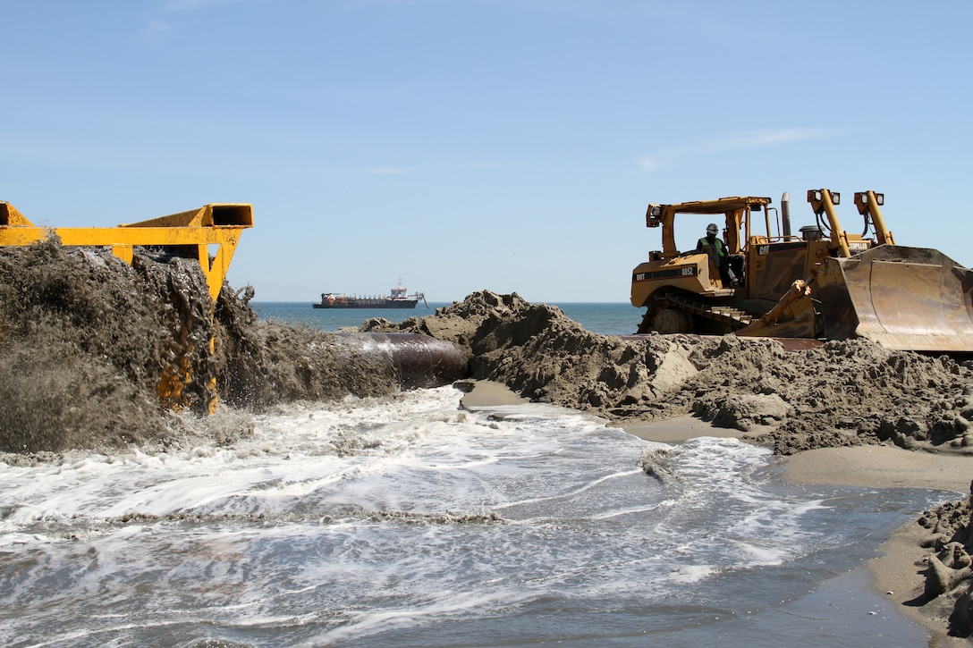 SANDBRIDGE, Va. – While the hopper dredge BE Lindholm is anchored off the coast pumping sand through a piping system onto Sandbridge beach through a strainer, dozers move the sand to widen the beach. Today the crew was working between the 2800 and 2900 block of Sandpiper Rd. The $13.35 million non-federal project included the dredging and placement of approximately 2 million cubic yards of sand along public beachfront from Back Bay National Wildlife Refuge to the Dam Neck Naval facility. 