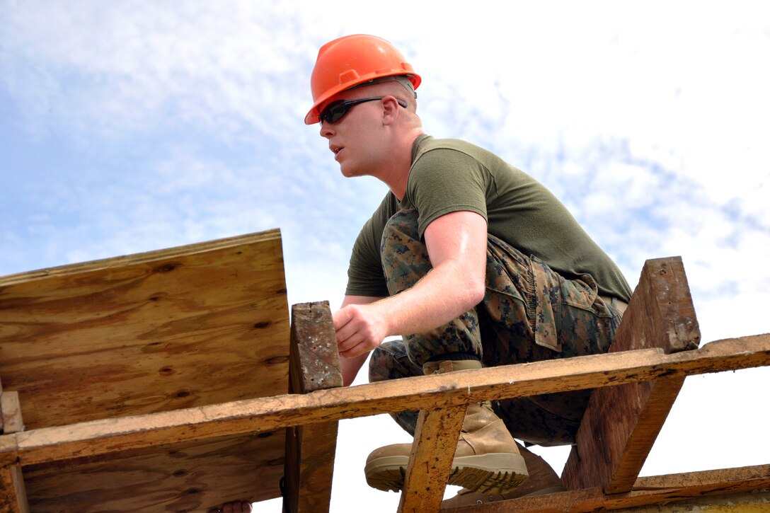U.S. Marine Corps Lance Cpl. Timothy Brotherton installs roof decking to repair a leaky roof at a Hattieville school as part of New Horizons in Hattieville, Belize, June 4, 2013. Brotherton, a combat engineer, is assigned to the Marine Wing Support Squadron 471.