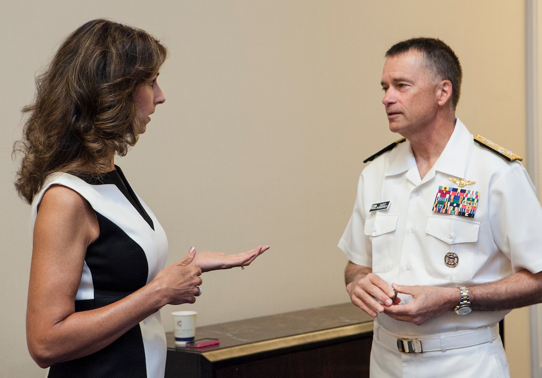 Carey Lohrenz, right, the Navy's first female F-14 Tomcat fighter pilot, and Navy Adm. James A. Winnefeld Jr., vice chairman of the Joint Chiefs of Staff, speak backstage at the 2013 Joint Women's Leadership Symposium in National Harbor, Md., June 6, 2013. 