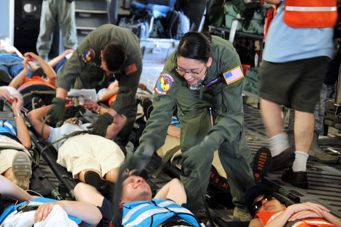 Air Force Senior Airman Milyn Kane secures a simulated patient for airlift in the cargo bay of a C-17 Globemaster III transport aircraft during Golden Eagle III on Stewart Air National Guard Base, N.Y. June 1, 2013. Kane, medical technician, is assigned to the New York Air National Guard's 139th Aeromedical Evacuation Squadron.