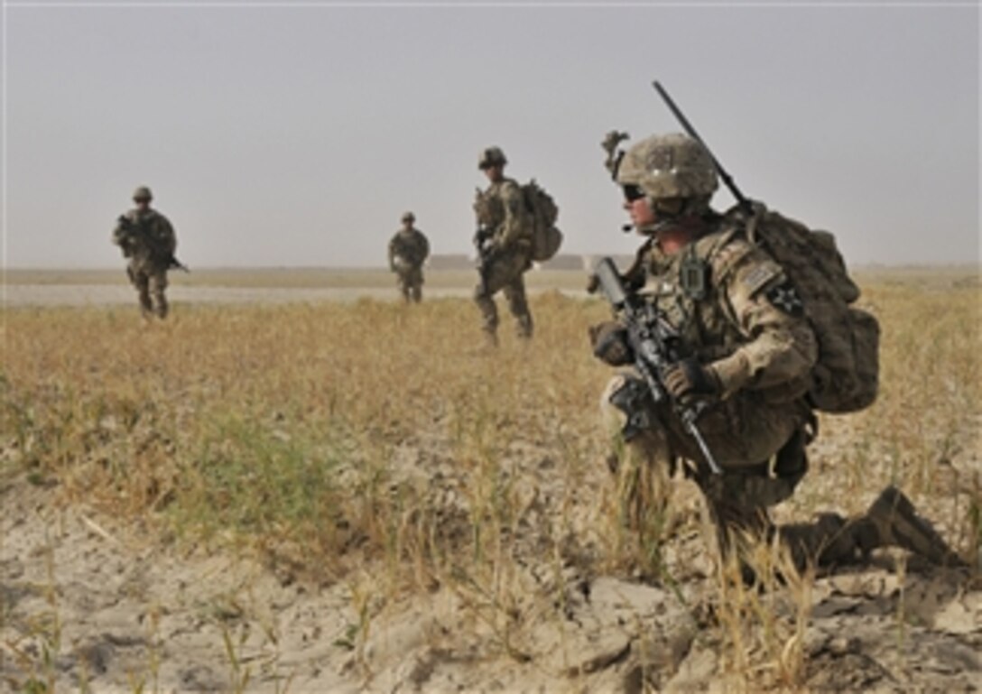 U.S. Army Spc. Jeremiah Carter, right, conducts a dismounted presence patrol with his unit near Forward Operating Base Spin Boldak in the Kandahar province of Afghanistan on June 2, 2013.  Carter and his fellow soldiers with Bravo Company, 2nd Battalion, 23rd Infantry Regiment are patrolling to meet area farmers and project force posture.  
