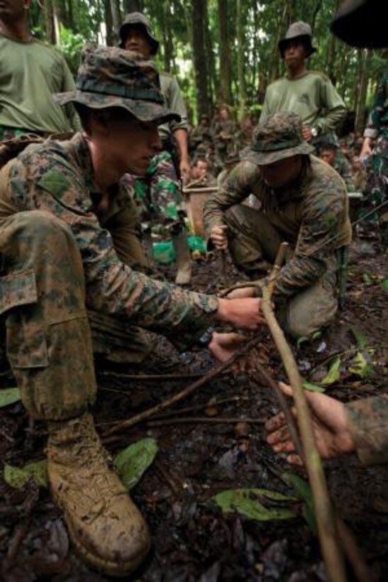 Indonesia Marines demonstrate survival techniques to U.S. Marines as a part of jungle survival training during Cooperation Afloat Readiness and Training 2013 May 26 in Antralina, Indonesia.