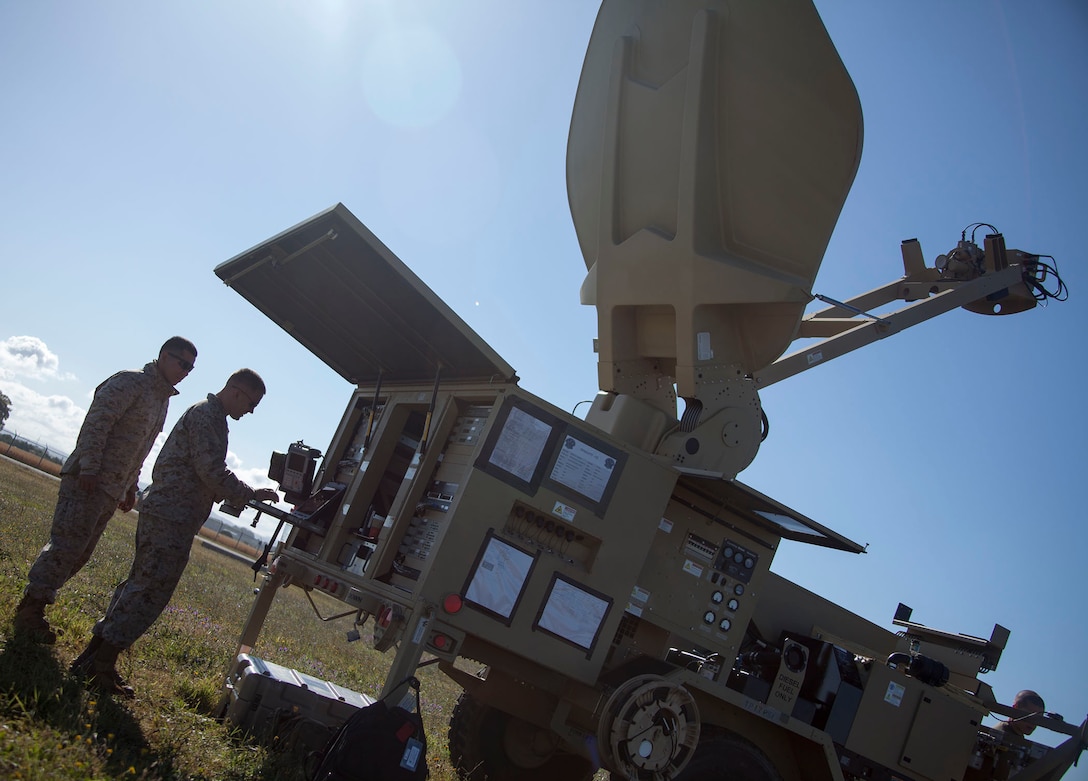 130520-M-WB921-044 MORON DE LA FRONTERA, Spain -- Corporal Cristobal Gomez, a Special-Purpose Marine Air-Ground Task Force Crisis Response satellite technician and San Antonio native, along with Sgt. Justin Hofelich, SP-MAFTF Crisis Response satellite communication chief and native of Madison, Ind., set up a Very Small-Aperture Terminal Large Satellite aboard Moron Air Base, May 20. "Satellite communications allow reliable and efficient communication support across the task force's area of responsibility, wherever we asked to go," said Capt. John Schreiner, the communications officer for SP-MAGTF Crisis Response and Sandusky, Ohio native. The SP-MAGTF Crisis Response is a rotational force of approximately 500 Marines and sailors sourced from a variety of Marine Corps units to include II Marine Expeditionary Force, Camp Lejeune, N.C., according to the force's requirement and their mission of being task organized, rapid-deployment force within the African regional reach to respond to crisis and defend U.S. security interests. (Marine Corps photo by Lance Cpl. Caleb McDonald/Not Released)