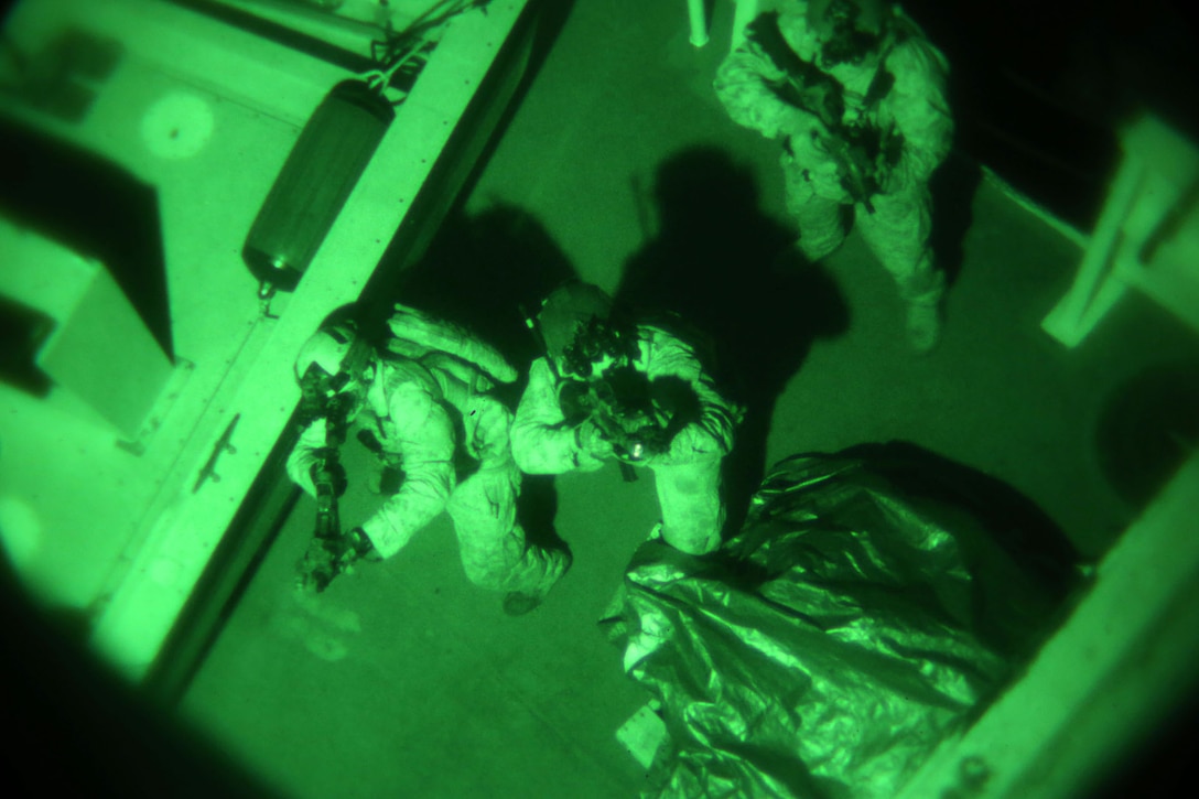 Members of 1st Marine Special Operations Battalion practice boarding and takedown of a ship at night. Marines train for Visit, Board, Search and Seizure (VBSS) at the highest level. This type of interdiction involves a non-compliant ship, underway, opposed, and at night.