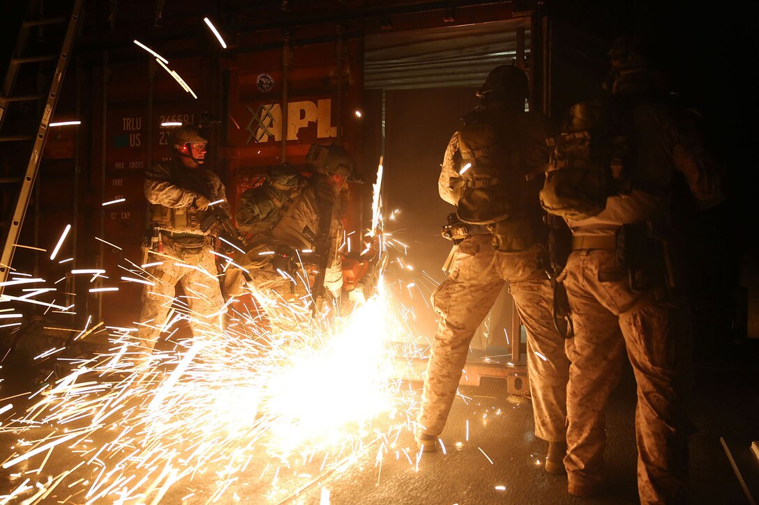 Members of 1st Marine Special Operations Battalion practice breaching on board ship at night. Marines train for Visit, Board, Search and Seizure (VBSS) at the highest level. This type of interdiction involves a non-compliant ship, underway, opposed, and at night. 