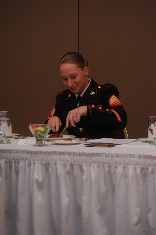 Sgt. Stephany Rector, president of the mess, tastes the beef before declaring it fit to serve to the “mess” during the Headquarters Company Mess Night aboard Marine Corps Base Quantico on June 5, 2013. The taste test was one of several Marine Corps traditions that are a part of the ceremonial dinner