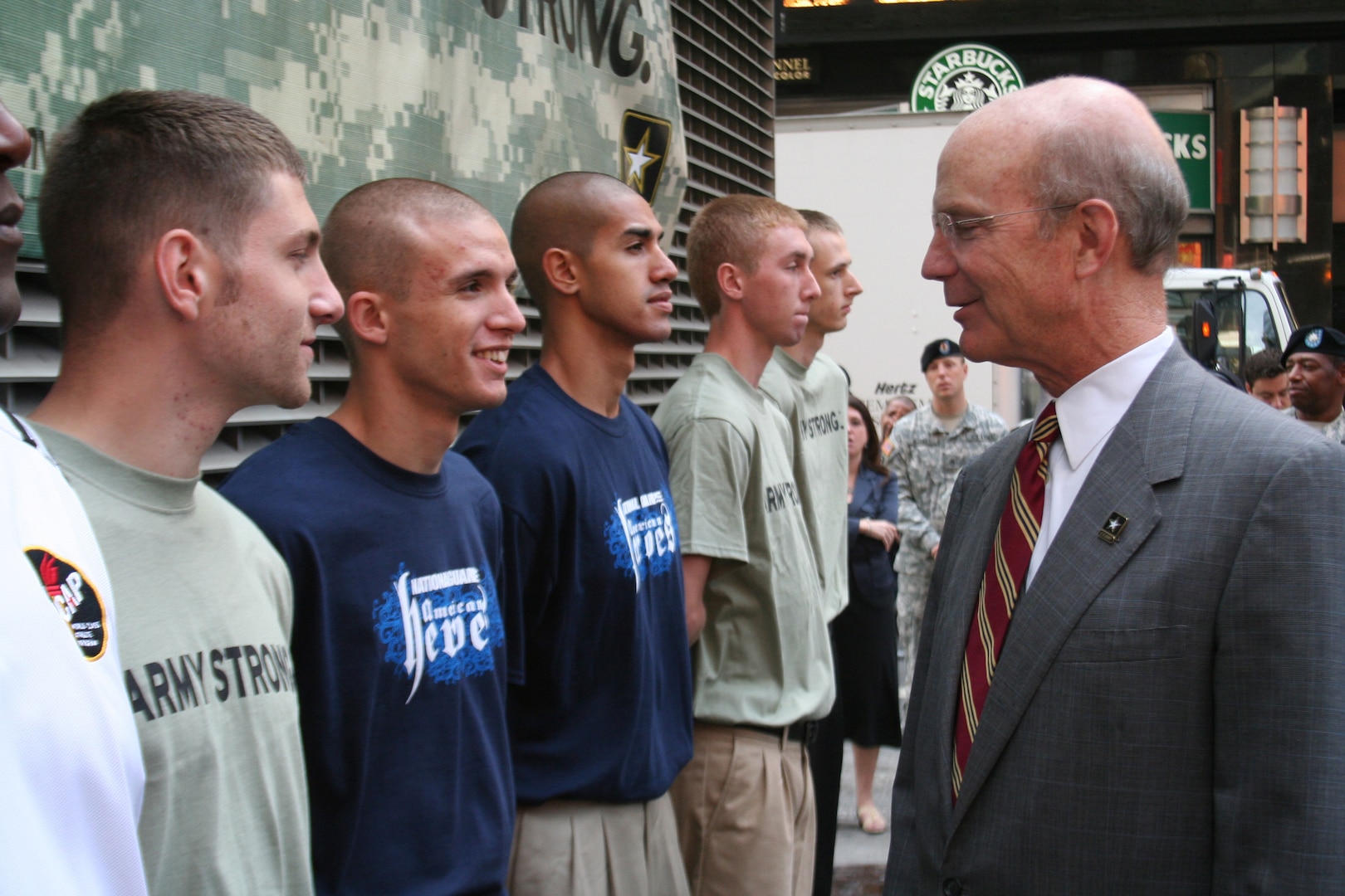 Secretary of the Army Peter Geren speaks congratulates the Army National Guard's newest Citizen Soldier Justin Sanders (at left) and Joseph Rios at the Army's recruiting ceremony October 1 at the Times Square Recruitment Center in New York City. The event marked the Army's achievement of its 2008 recruiting effort, bringing in more than 170,000 new Soldiers to the Army, the Army Reserve and the Army National Guard. Sanders, from the Utah Army National Guard and Rios, from the New York Army National Guard, received their oath of enlistment from General William Wallace, commander of the Army's Training and Doctrine Command. Members of the Army, Army Reserve and Army National Guard were all represented in the enlistment ceremony.