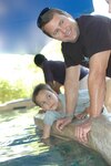 Dominic Magne and Lt. Col. Scott Reinhold pet stingrays and sharks at the Phoenix Zoo, Oct. 30. The second-grader and the F-16 pilot have remained friends since Dominic visited the 162nd Fighter Wing in Tucson, Ariz., last year to fulfill his dream to become a fighter pilot.