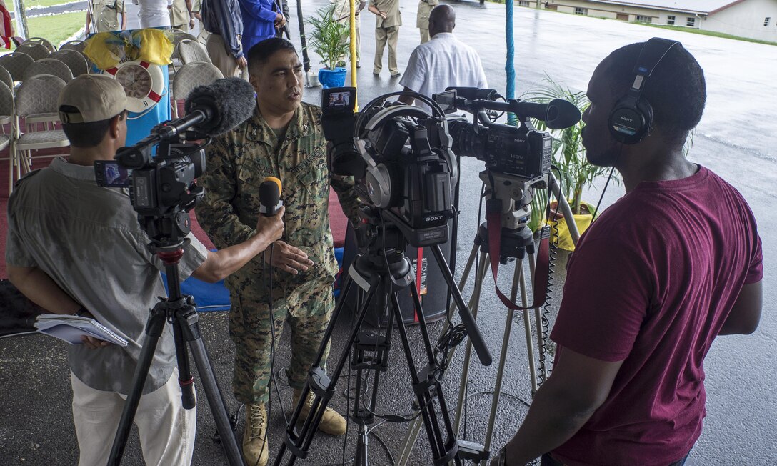 U.S. Marine Corps Col. Augustine Bolanio, Director of Exercises for U.S. Marine Corps South, speaks with Saint Lucian media during the opening ceremony of Tradewinds 2013. Tradewinds 2013 is a joint, combined exercise conducted in conjunction with partner nations to enhance the collective abilities of defense forces and constabularies to counter transnational organized crime and to conduct humanitarian/disaster relief operations. (U.S. Navy photo by Mass Communication Specialist 1st Class Paul Seeber/Released)