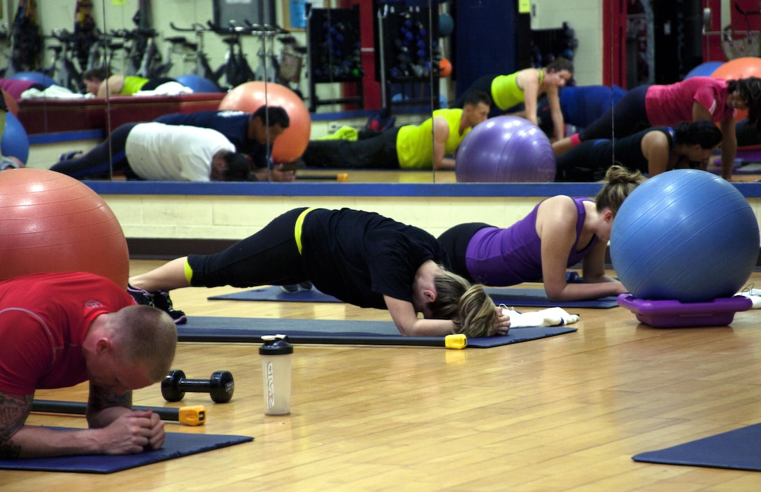 MARINE CORPS BASE HAWAII - Participants push themselves during the Ab Express class at the Semper Fit Center on Marine Corps Base Hawaii, May 23. There are a variety of exercises, working the participant’s entire core, back, legs and also helping their balance.(U.S. Marine Corps photo by Lance Cpl. Janelle Y. Chapman)