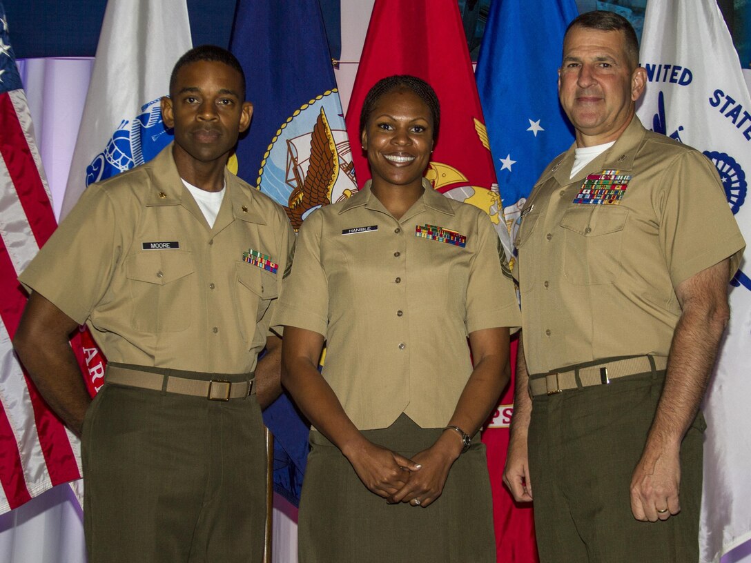 Gunnery Sgt. Tawanda Hanible, diversity operations chief, Marine Corps Recruiting Command (center) takes a picture with Maj. Frank Moore, diversity officer, MCRC, and Col. Robert G. Golden III, chief of staff, MCRC, during the Sea Service Leadership Association's Joint Leadership Awards Luncheon at the Gaylord National Resort and Conference Center here, June 6. Hanible received the Major Megan McClung Leadership Award during the luncheon. 