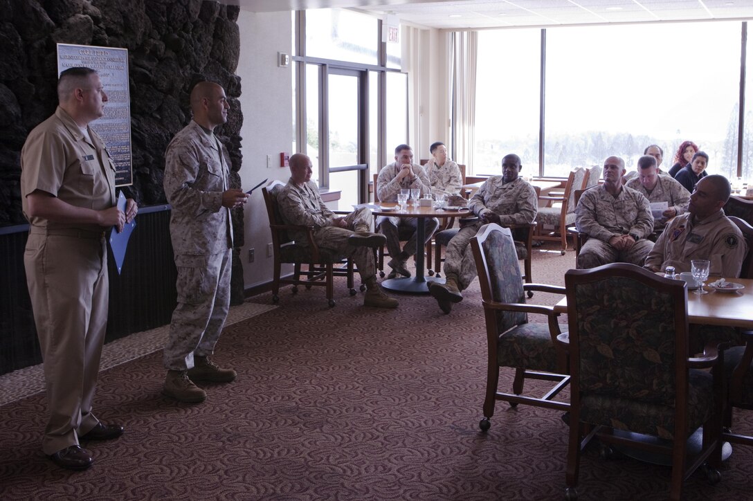 Marine Corps Base Hawaii - Chief Warrant Officer 2 Ioannis Vrachnos (second from left), the Marine units Navy-Marine Corps Relief Society coordinator and native of Bridgeport, Conn., congratulates Marines and sailors for raising $156,000 for the 2013 annual Active Duty Fund Drive, $20,000 more than the previous year. (U.S. Marine Corps photo by Cpl. James Sauter)