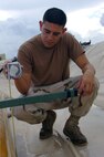 Air Force Senior Airman Albert Leyvas checks fuel levels on a bladder at Joint Task Force Guantanamo's Expeditionary Legal Complex, Nov. 3, 2008. Leyvas calculates the amount of fuel each bladder contains and determines how much needs to be added to ensure the bladder is kept at an operational level.