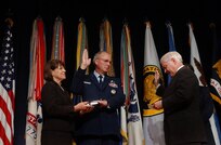 As his wife Cheryl McKinley holds a bible, Air Force Gen. Craig R. McKinley is sworn in by Secretary of Defense Robert Gates as the 26th chief of the National Guard Bureau during a ceremony at the Pentagon, where he was also promoted to his current rank, Monday, Nov. 17, 2008. McKinley is the first Guard officer to be promoted to the four-star rank.