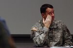 Capt. Adrian Perez collects his thoughts while recounting his story of recovering from wounds sustained in Iraq. Perez, of the Army National Guard's Manpower Analysis section, spoke at the Army National Guard Readiness Centeras part of Wounded Warrior Awareness Day, Wednesday, Nov. 19, 2008.