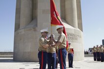 Maj. Thomas B. Mcgee, right, passes the Marine Corps organizational colors to Maj. Alfred L. Butler IV, left, during a change of command ceremony at the Liberty Memorial, June 7. Butler assumed command of Recruiting Station Kansas City.